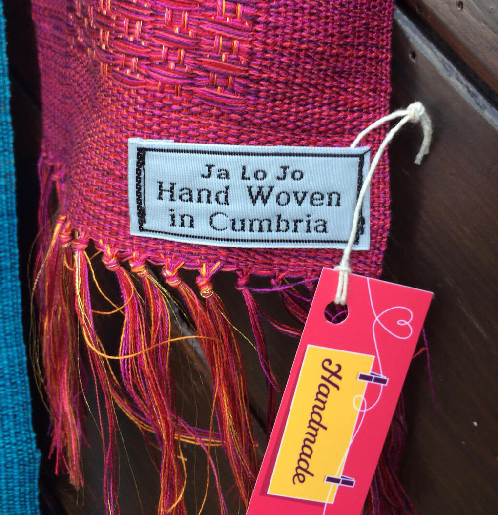 Dark pink scarf showing JaLoJo label – handcrafted textile detail